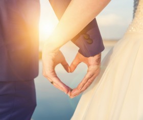 Romantic couples heart-shaped gesture Stock Photo