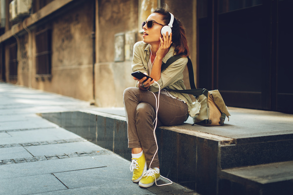 Sitting on the street listening to music Stock Photo