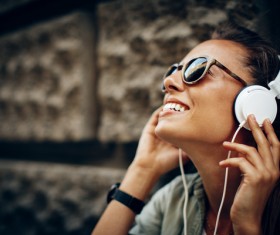 Smiling woman wearing headphones Stock Photo