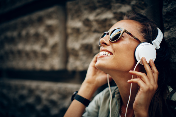 Smiling woman wearing headphones Stock Photo