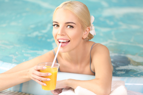 Stock Photo Girl drinking juice in a jacuzzi 02