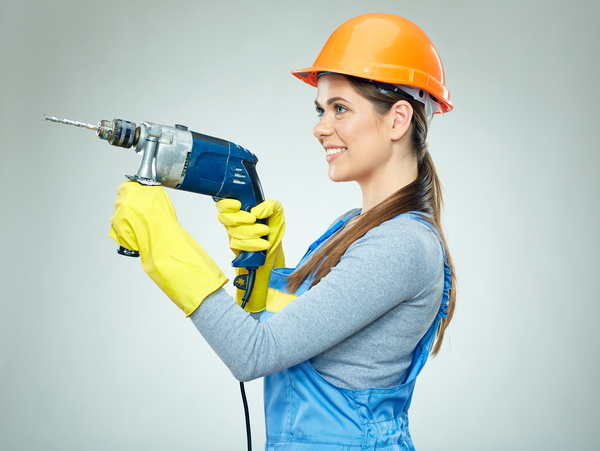 Take a female worker with an electric drill Stock Photo