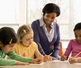 Teacher and homework of the children Stock Photo