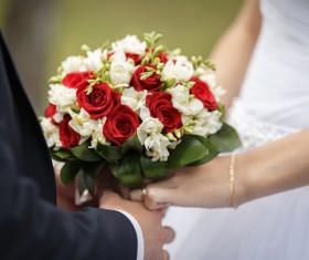The bride and groom hold the bouquet Stock Photo