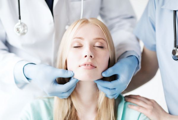 The doctor checks the patients tonsils Stock Photo