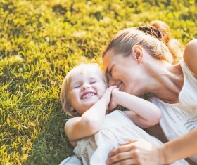 The mother and daughter lying on the grass Stock Photo