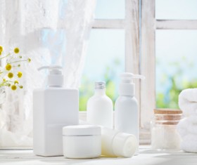 The windowsill is placed with cosmetics and towels Stock Photo