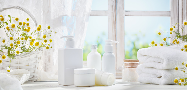 The windowsill is placed with cosmetics and towels Stock Photo