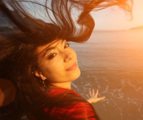 The woman on the beach looking back Stock Photo