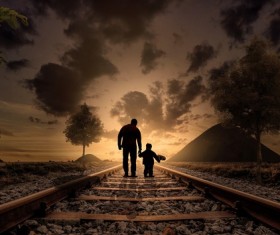 Walking on railroad father with children Stock Photo