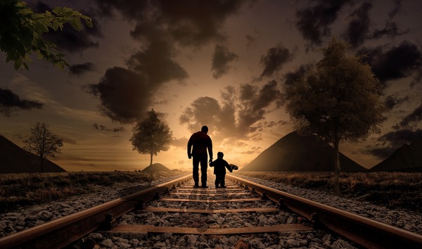 Walking on railroad father with children Stock Photo