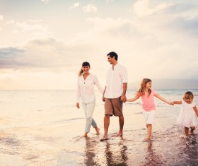 Walking on the beach a happy family of four Stock Photo