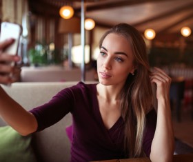 With a smart phone self-timer woman Stock Photo