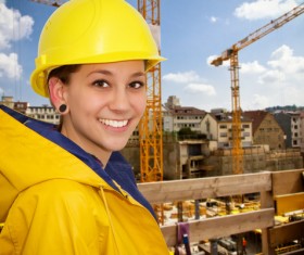 Woman wearing a raincoat at the construction site Stock Photo