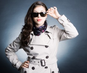 Woman wearing a trench coat with sunglasses Stock Phot