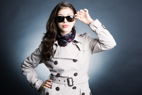 Woman wearing a trench coat with sunglasses Stock Phot