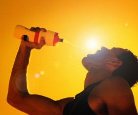 man who drinks water in the hot sun Stock Photo