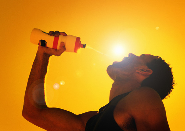 man who drinks water in the hot sun Stock Photo
