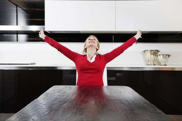 woman stretching her arms at the table Stock Photo