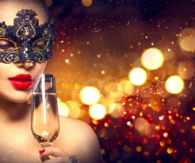 woman with a mask drinking champagne Stock Photo