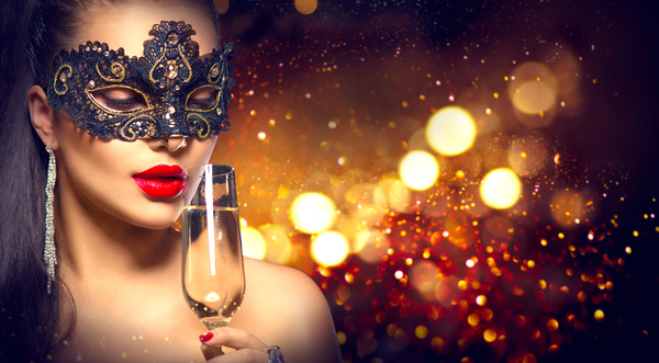 woman with a mask drinking champagne Stock Photo