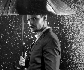 A handsome man with an umbrella Stock Photo