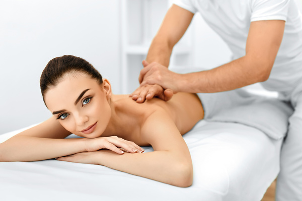 Beautician for the customer body care Stock Photo