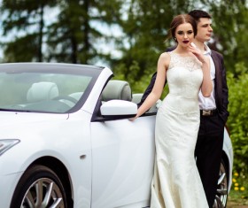 Beautiful bride and groom near the wedding car Stock Photo 01