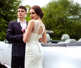 Beautiful bride and groom near the wedding car Stock Photo 02
