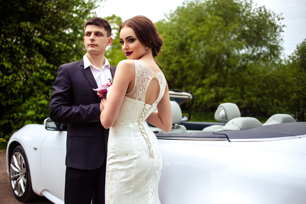 Beautiful bride and groom near the wedding car Stock Photo 02