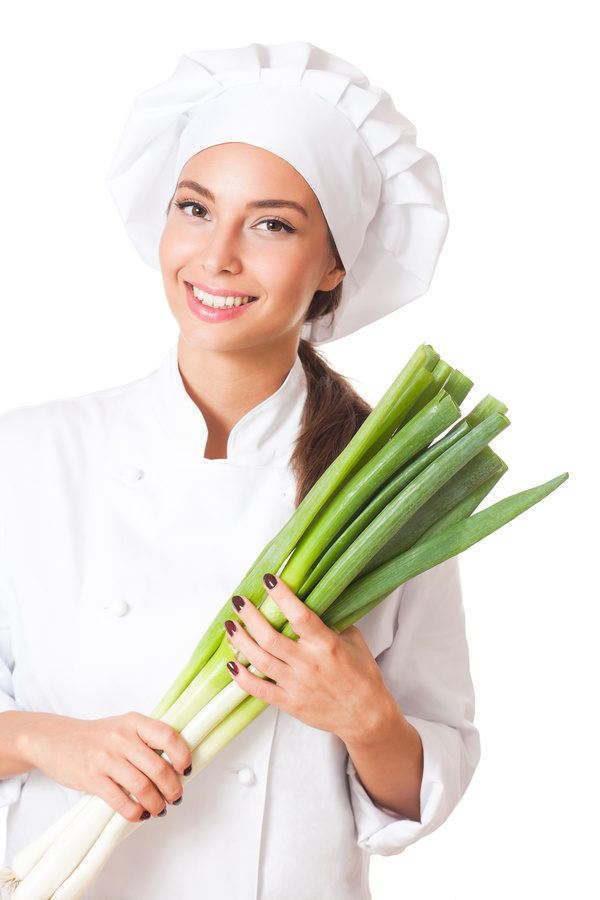 Beautiful female chef holding a green onions Stock Photo