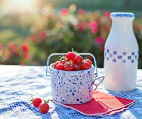 Cherry Tomatoes and bottled milk on the table Stock Photo