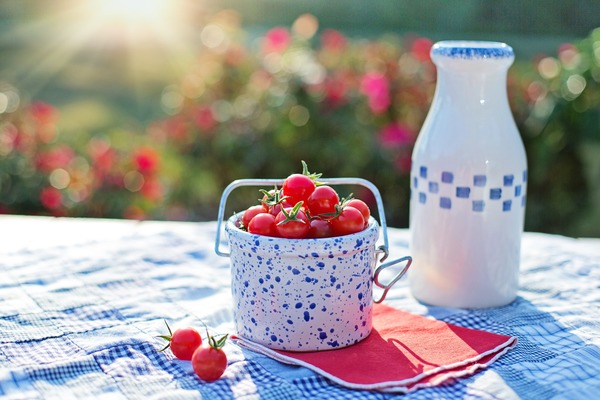 Cherry Tomatoes and bottled milk on the table Stock Photo