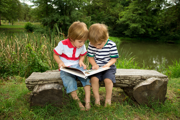 Comic books together to see two children Stock Photo