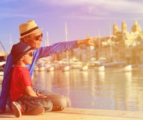 Father and son rest in the dock Stock Photo