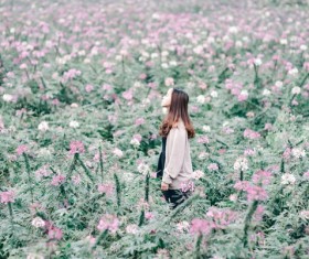 Girl standing in the flowers Stock Photo