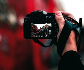 Hand holding modern digital camera Stock Photo