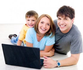 Happy family before the computer Stock Photo