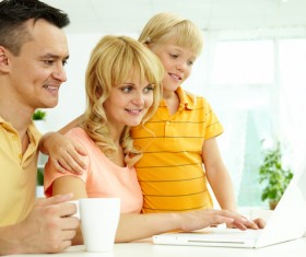 Happy family using a computer together Stock Photo