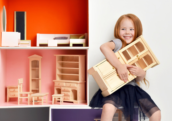 Happy little girl playing doll house filled with mini furniture toys Stock Photo 04