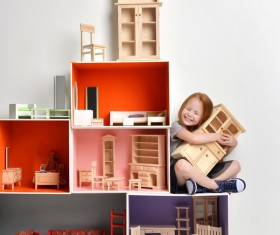 Happy little girl playing doll house filled with mini furniture toys Stock Photo 05