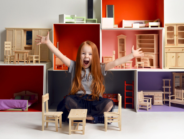 Happy little girl playing doll house filled with mini furniture toys Stock Photo 06