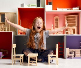 Happy little girl playing doll house filled with mini furniture toys Stock Photo 08