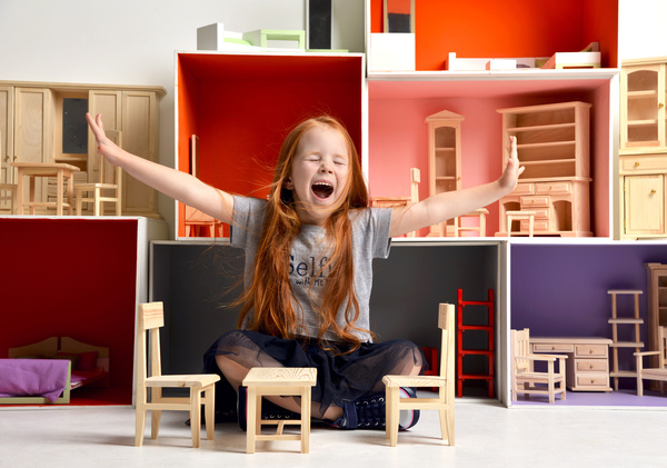 Happy little girl playing doll house filled with mini furniture toys Stock Photo 08