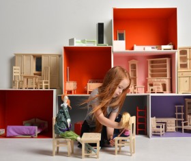 Happy little girl playing doll house filled with mini furniture toys Stock Photo 09