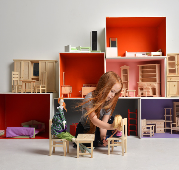 Happy little girl playing doll house filled with mini furniture toys Stock Photo 09