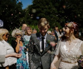 Happy marriage couple among cheering Stock Photo