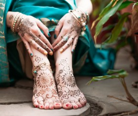 Indian women show hands feet Mehndi Stock Photo