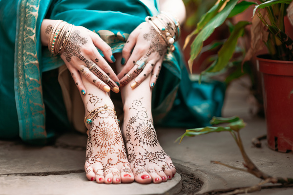 Indian women show hands feet Mehndi Stock Photo