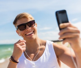 Listening to music with a smartphone Man Stock Photo